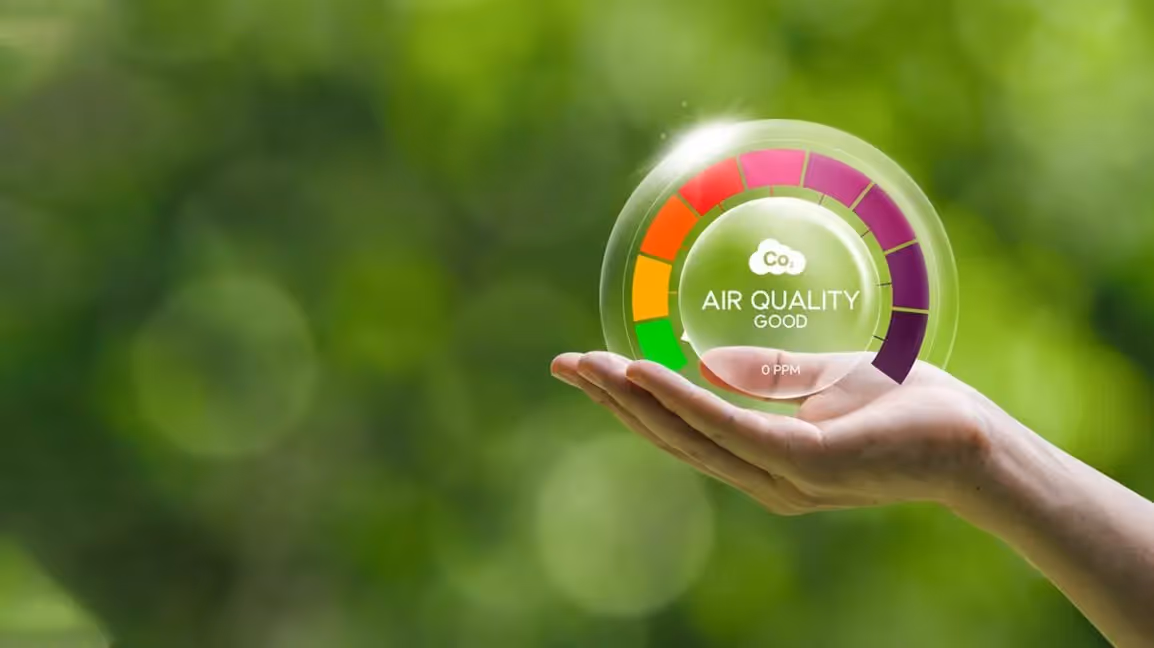 Hand hovering under floating air-quality icon.