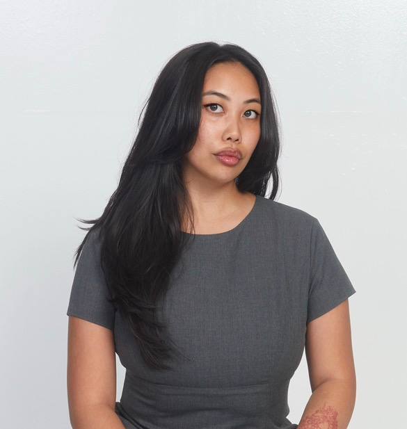 3 coworkers in a brick office with books in the background 