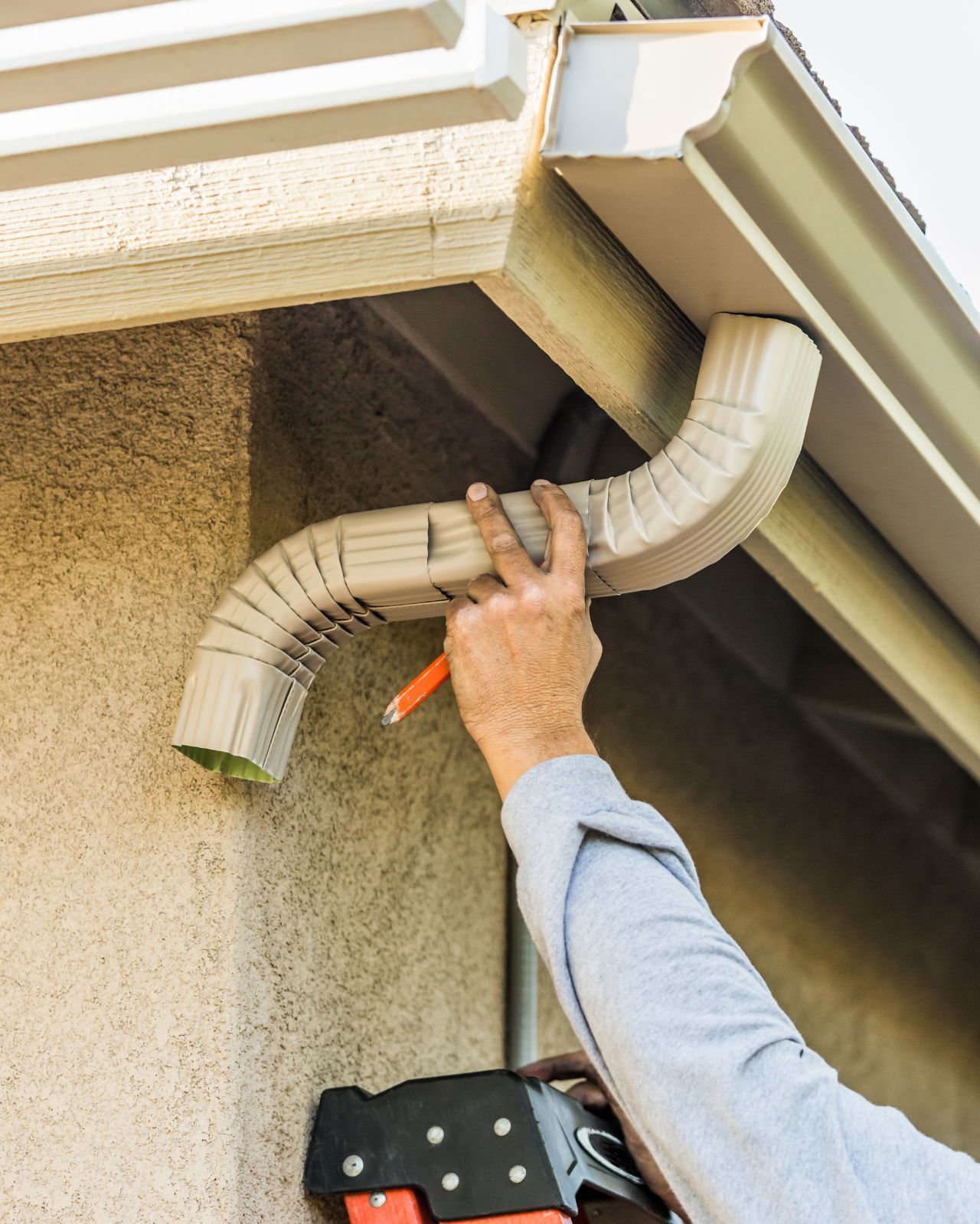Worker Attaching Aluminum Rain Gutter