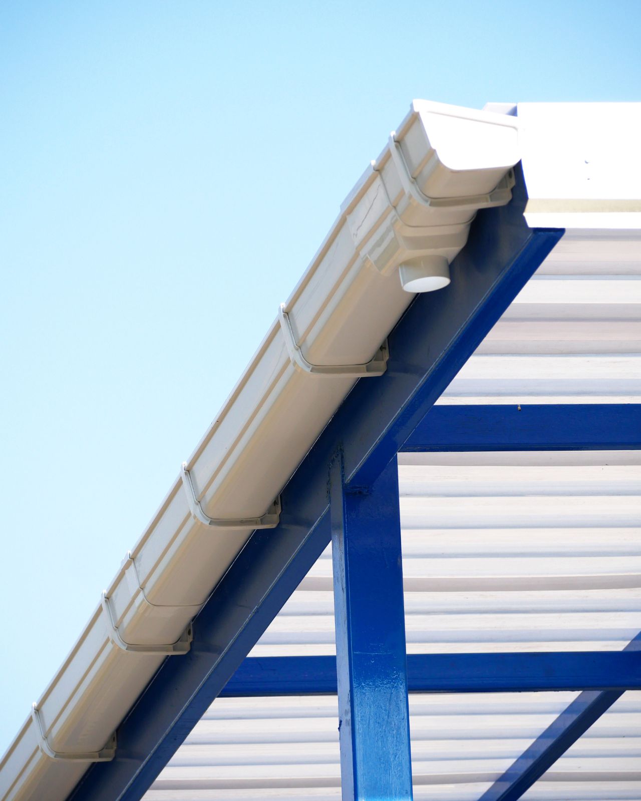 New rain gutter on blue sky background