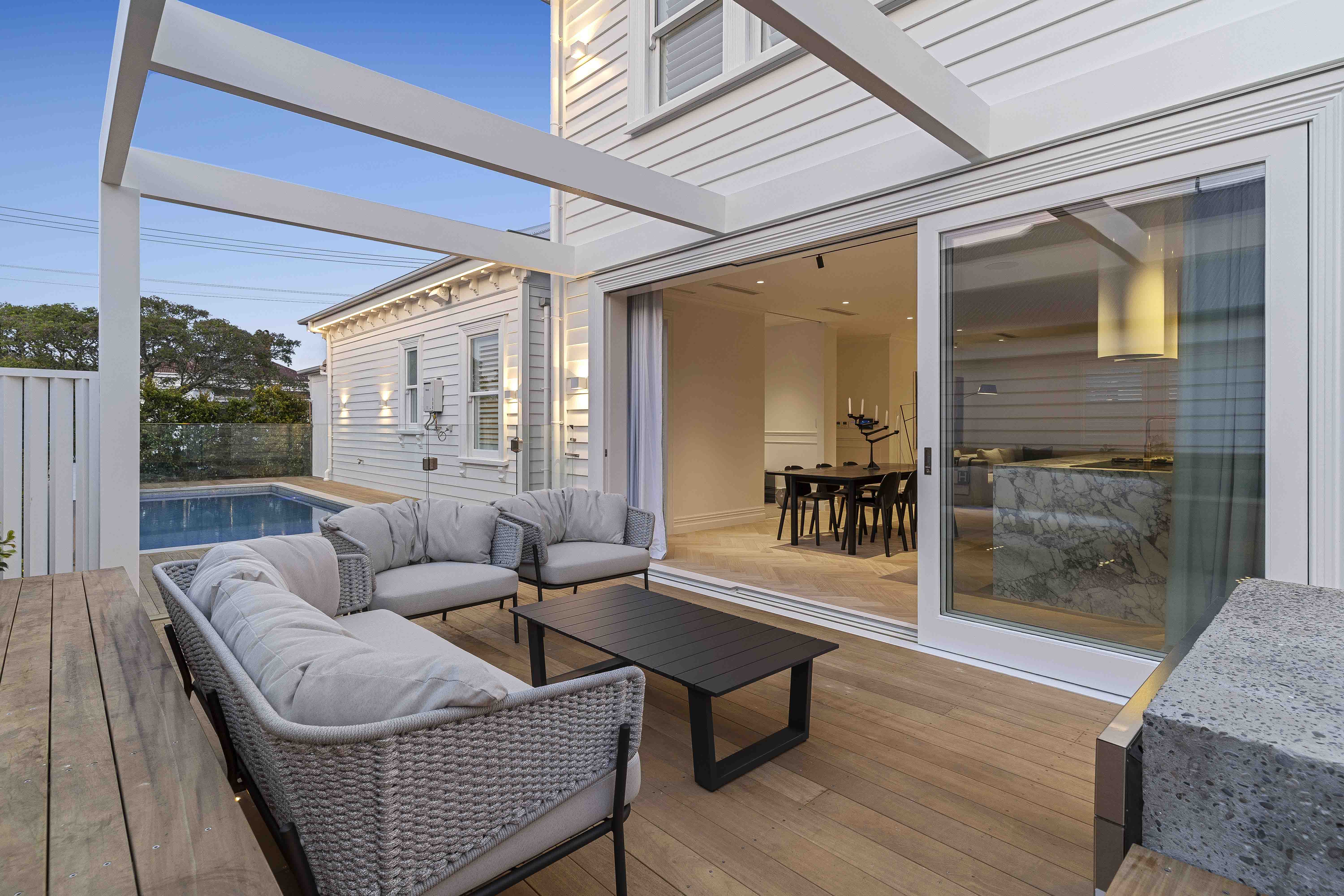 Outdoor patio with furniture and view of pool