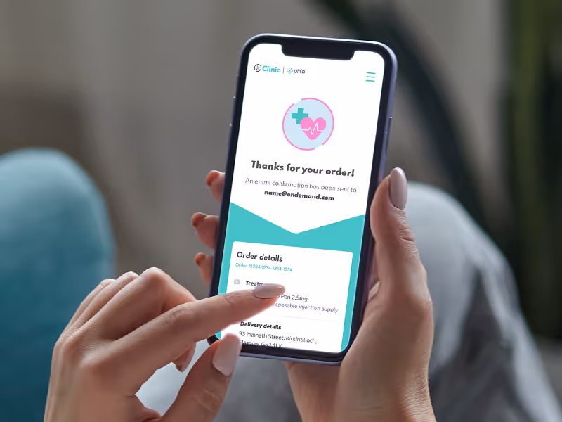 Person holding a smartphone displaying a weight loss order confirmation screen with treatment and delivery details.