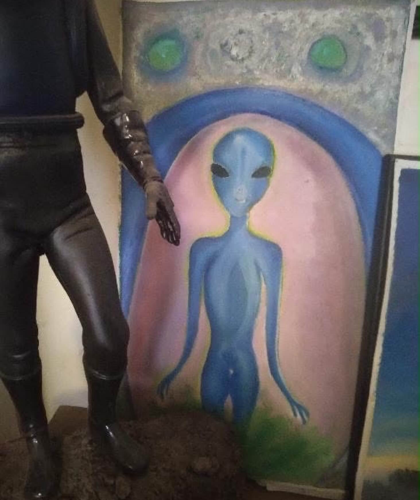 A painting of a blue alien.