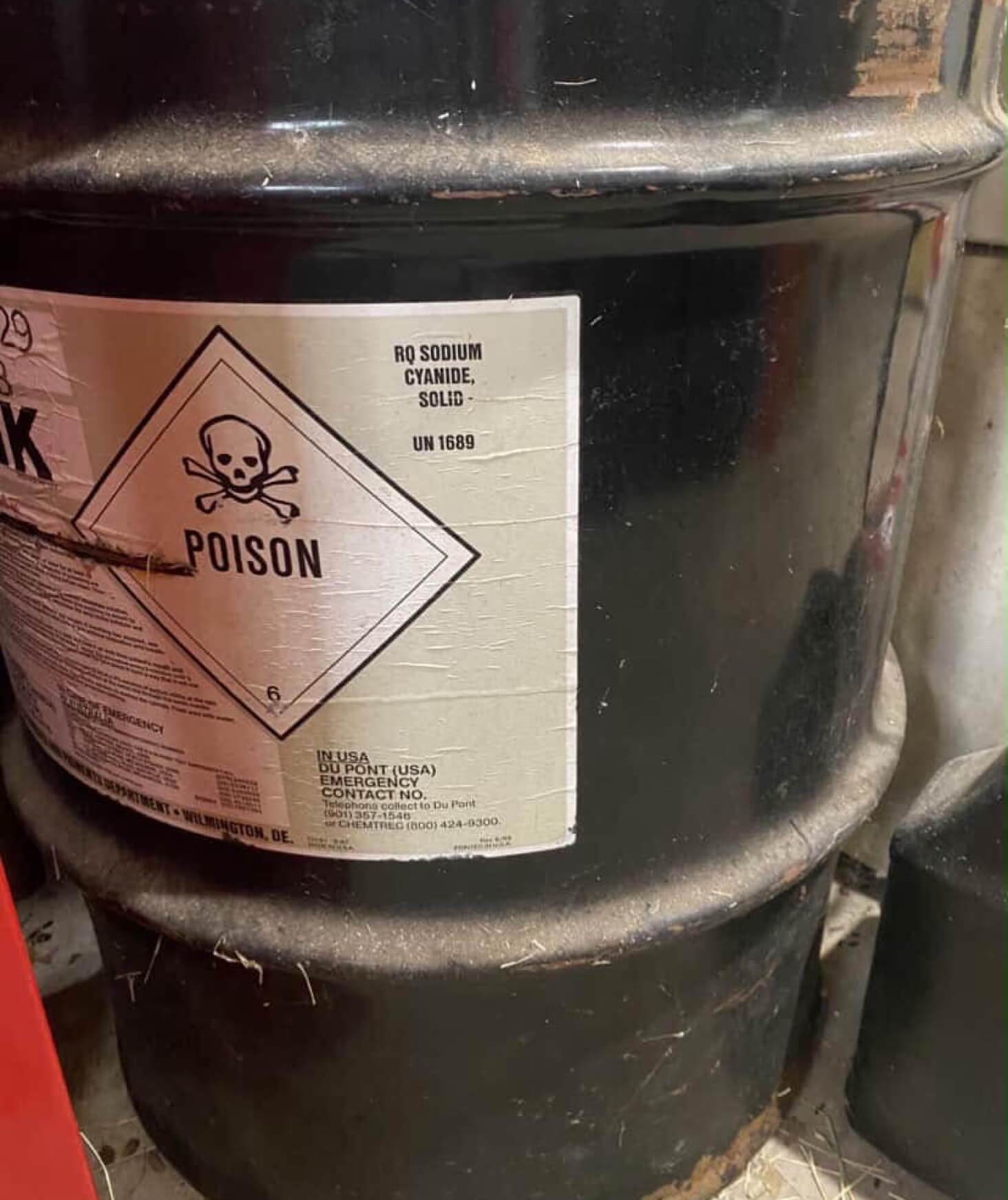A black bucket of sodium cyanide.