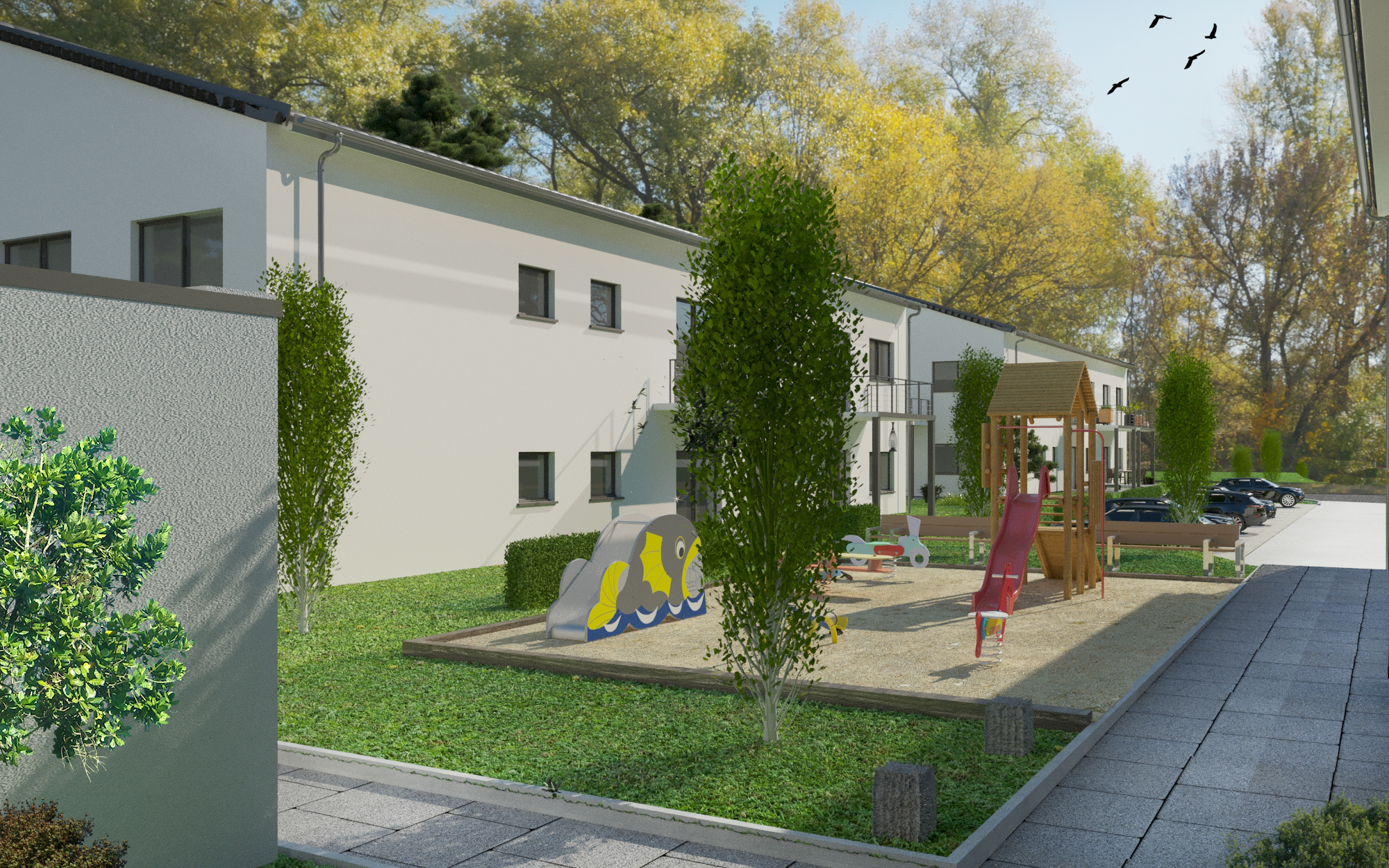 Wohnanlage mit hellen Gebäuden, Bäumen und Kinderspielplatz