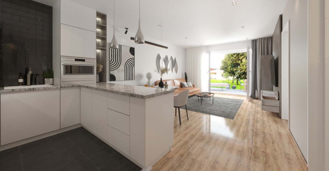 Moderner, heller Wohnbereich mit Sofa und integrierter Einbauküche mit Blick in den Garten