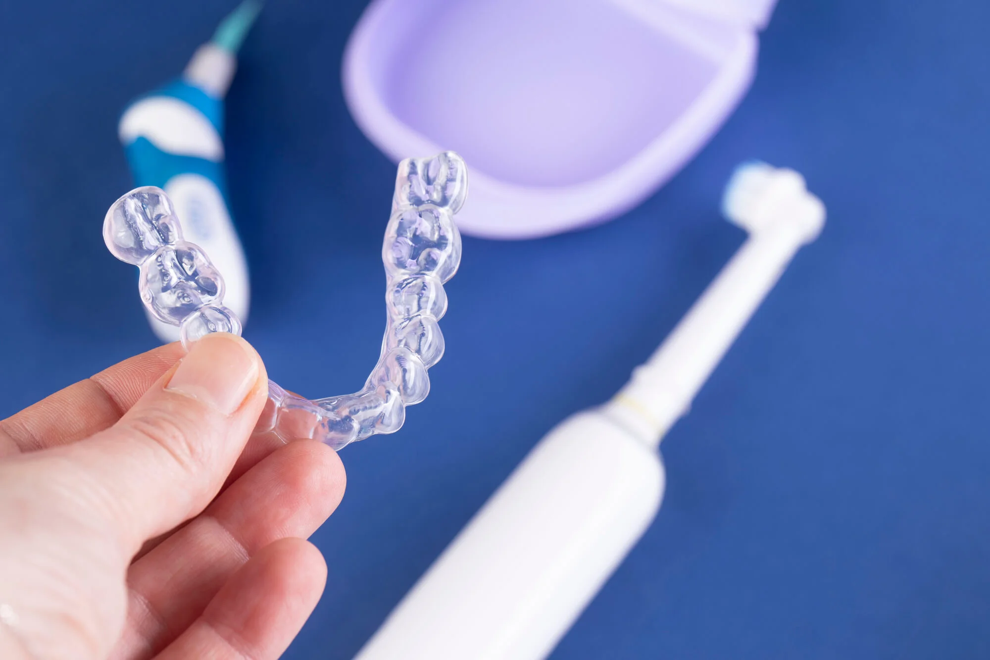 Person holding Invisalign, exploring Drexel Hill dentistry.