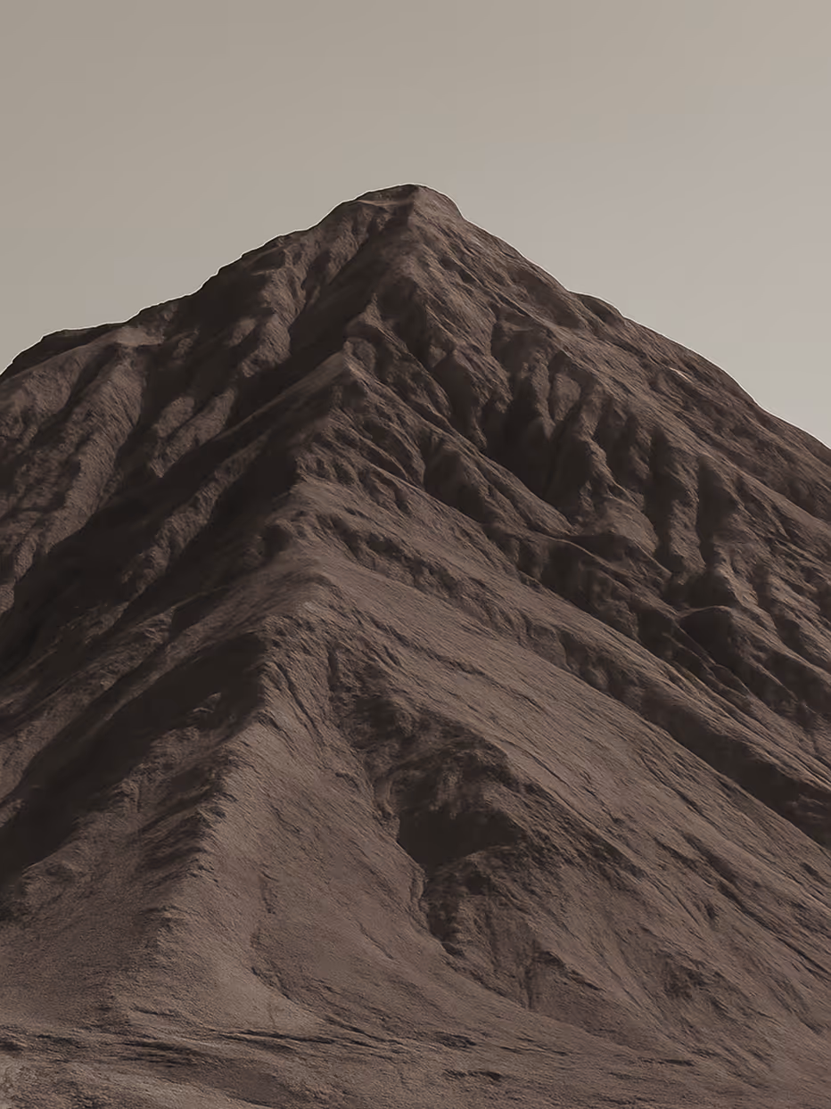 Close-up view of a rugged, steep mountain peak under a clear sky in monochrome tones.