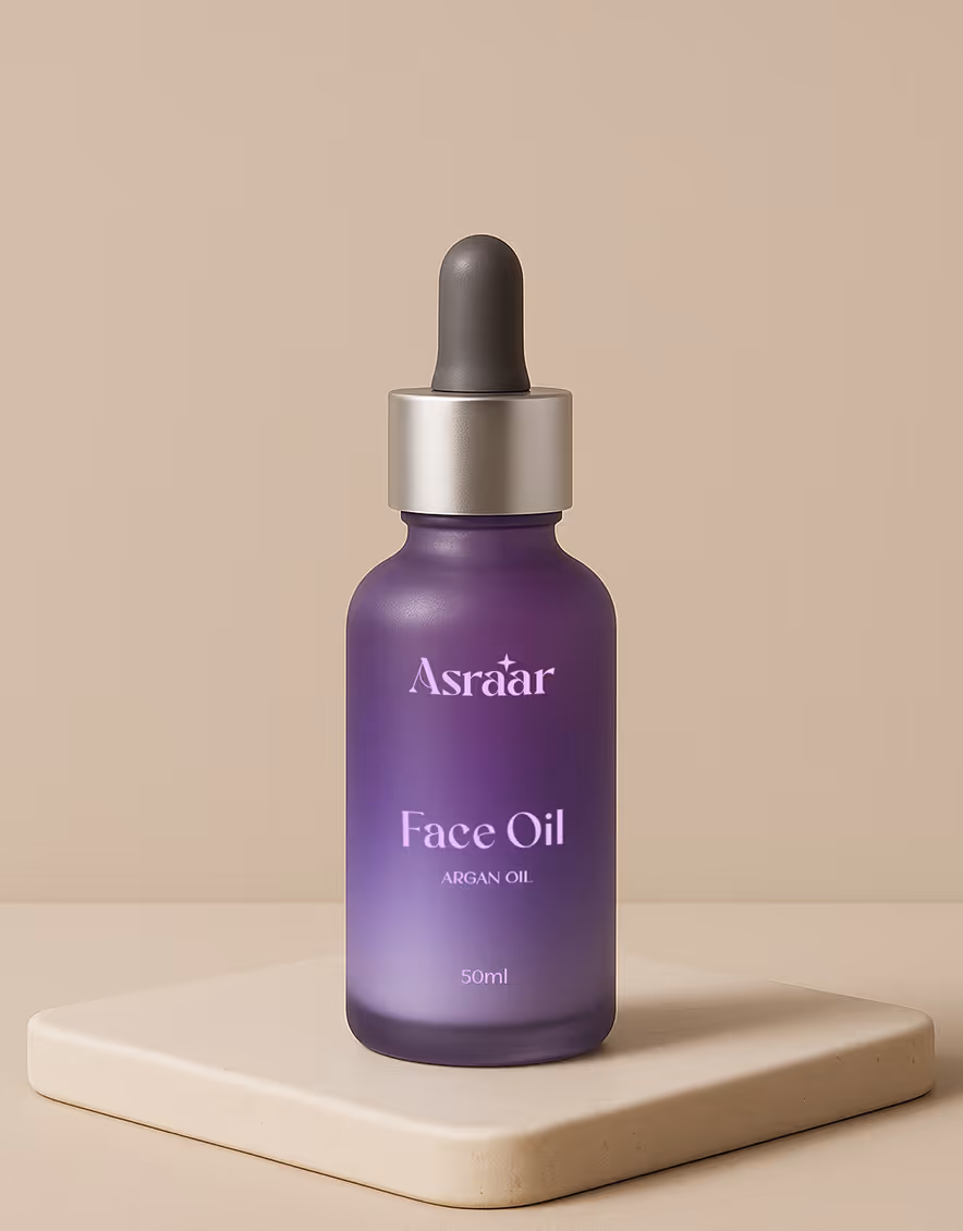 Purple glass bottle of Asraar Face Oil Argan Oil with dropper cap, 50ml, on a beige platform.