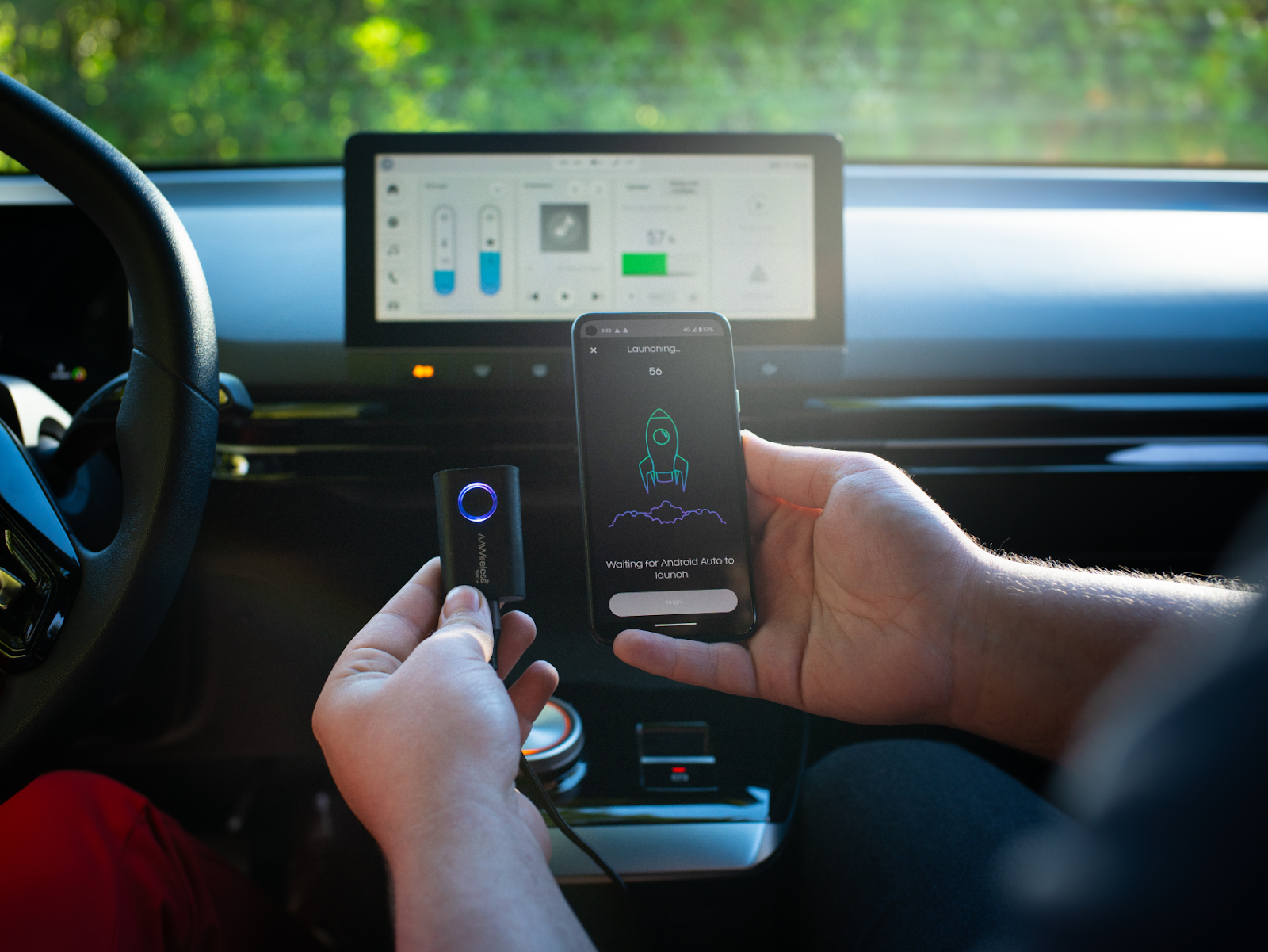 AAWireless adapter with phone in front of car dashboard