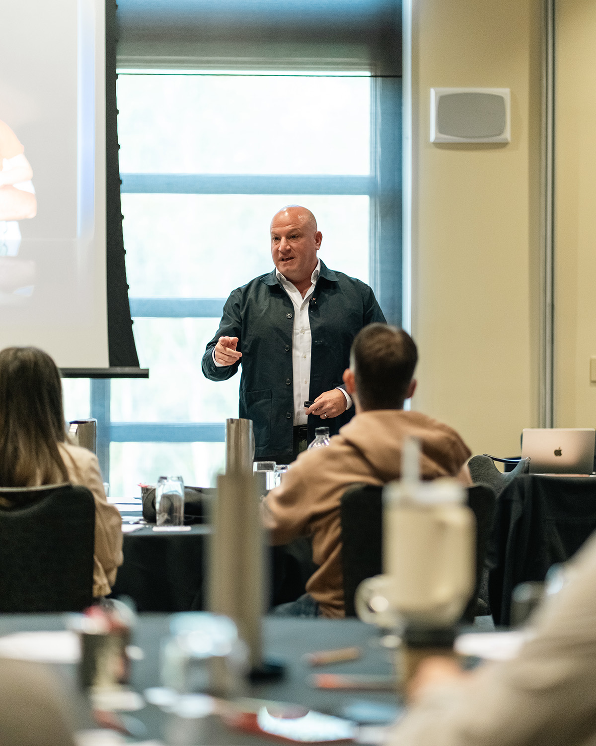 Marc Rousso delivering a keynote speech and interacting with the audience.