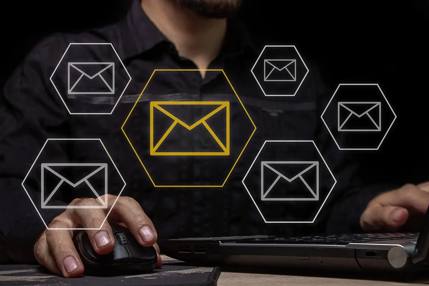 Dark digital background with outlined email icons in hexagons with a business person working with a single icon in gold