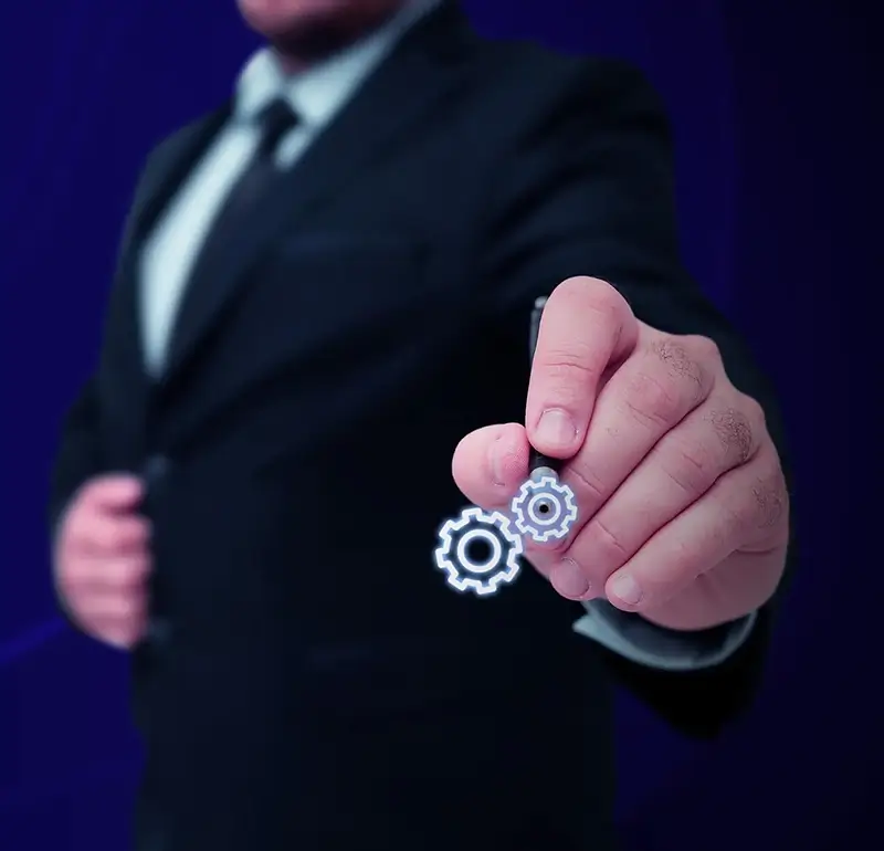 Dark digital image with 'Our Values' Text written in a graphic shape and a business men touching an cog icon
