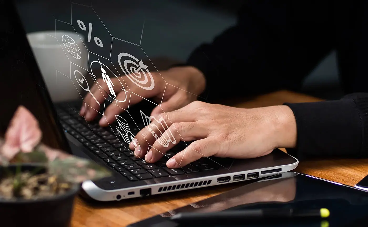 Dark laptop with lined digital communication icons in hexagons in a perspective angle hovering infront of the user