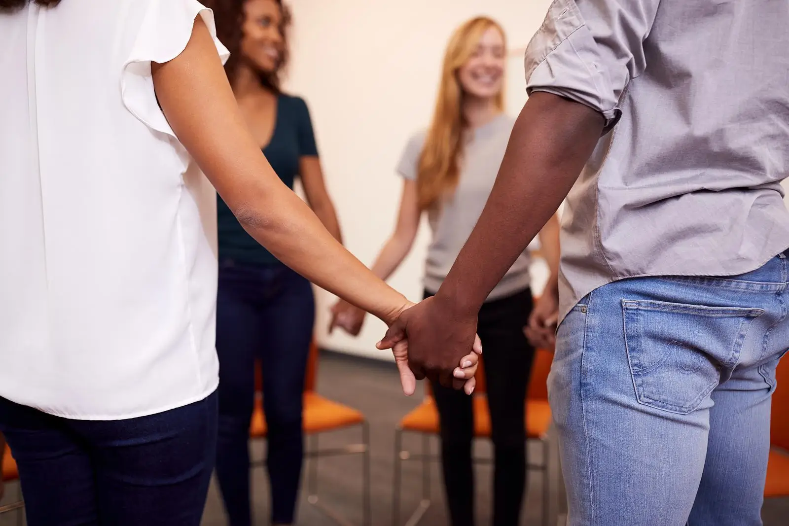 Religious group holding hands worshipping session