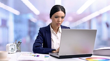 Busy Asian Woman In Suit Working