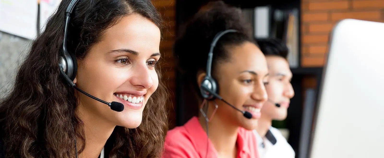 Smiling team of telemarketers