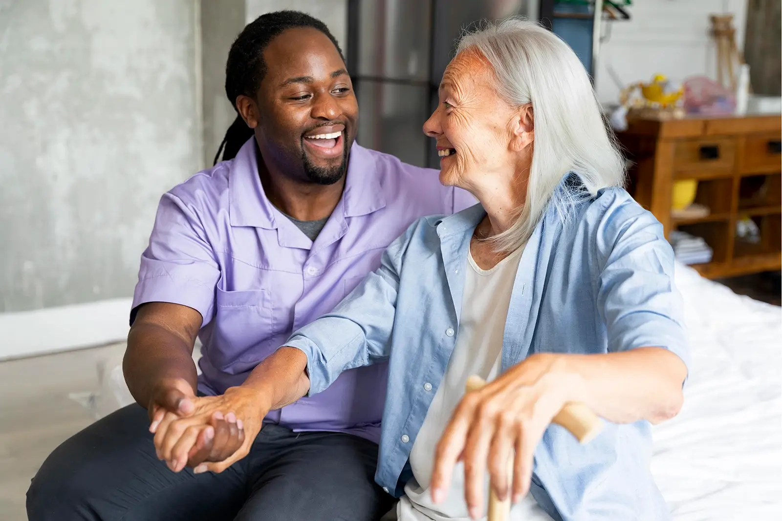 Smiling male carer looking after an elderly patient