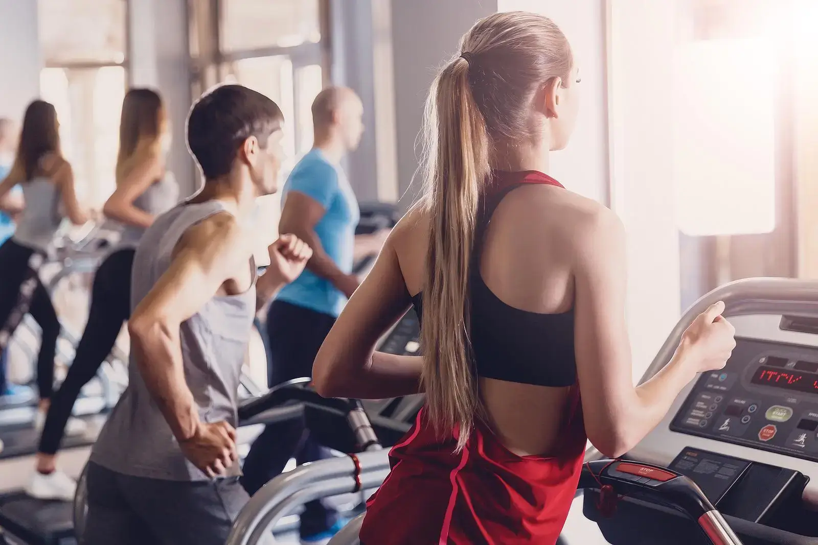 Group of people on treadmills running