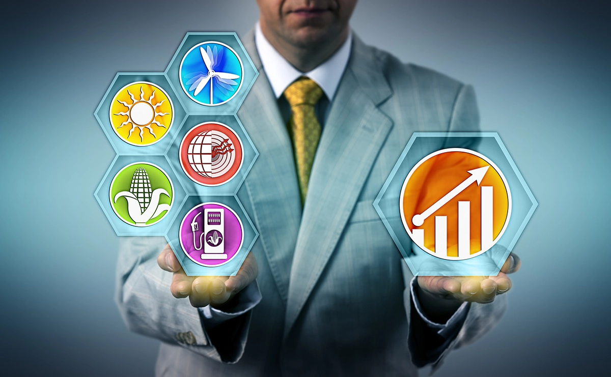 Man wearing a business suite with industry icons hovering above both his hands