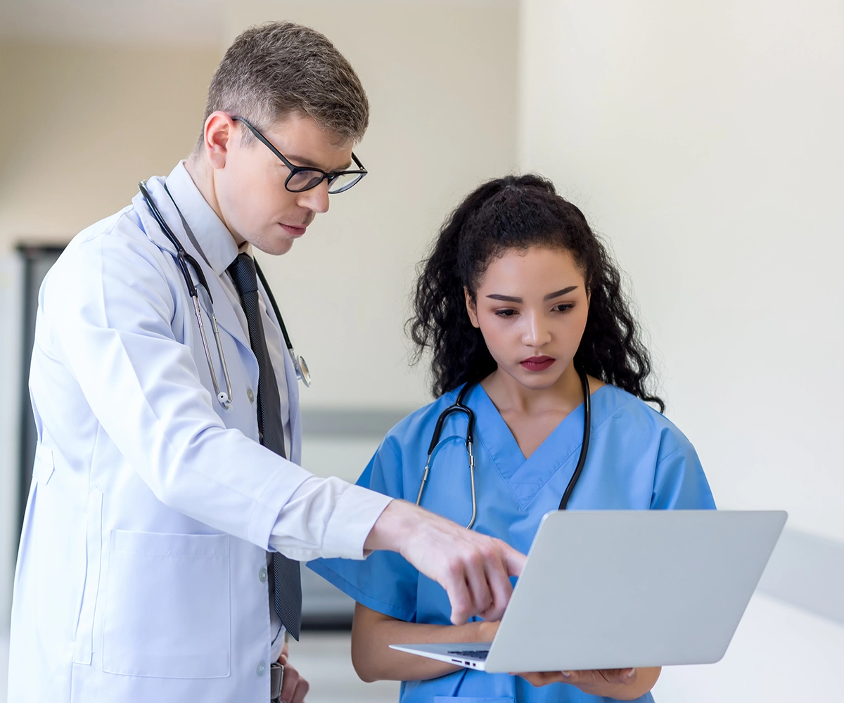 A doctor consulting a nurse in a hospital
