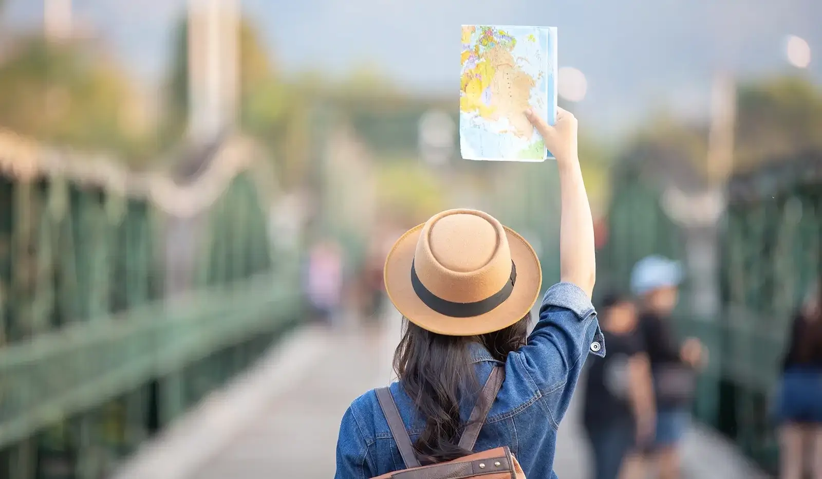 Young person traveling around holding a city map