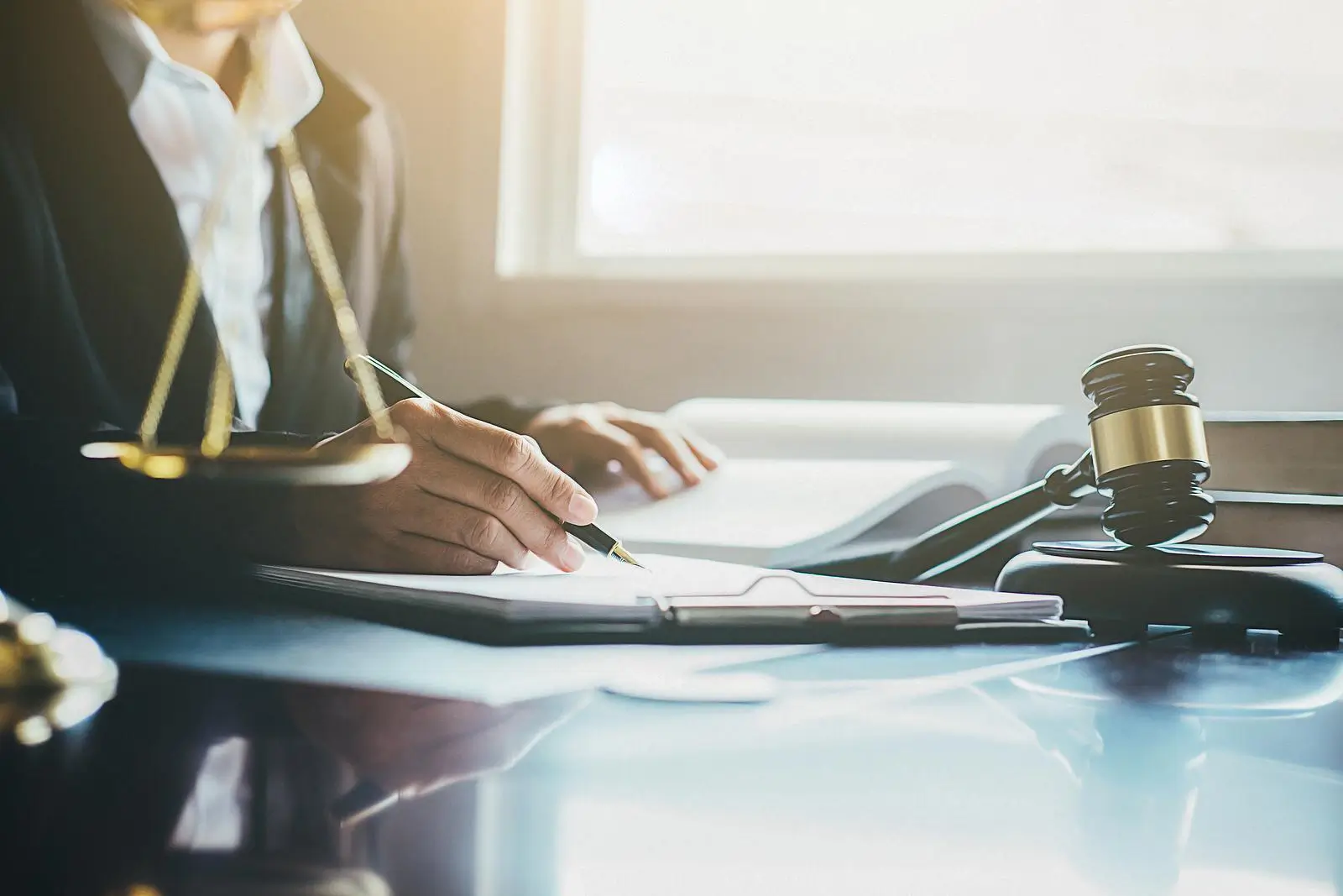 Close-up of a judges gavel signing a document