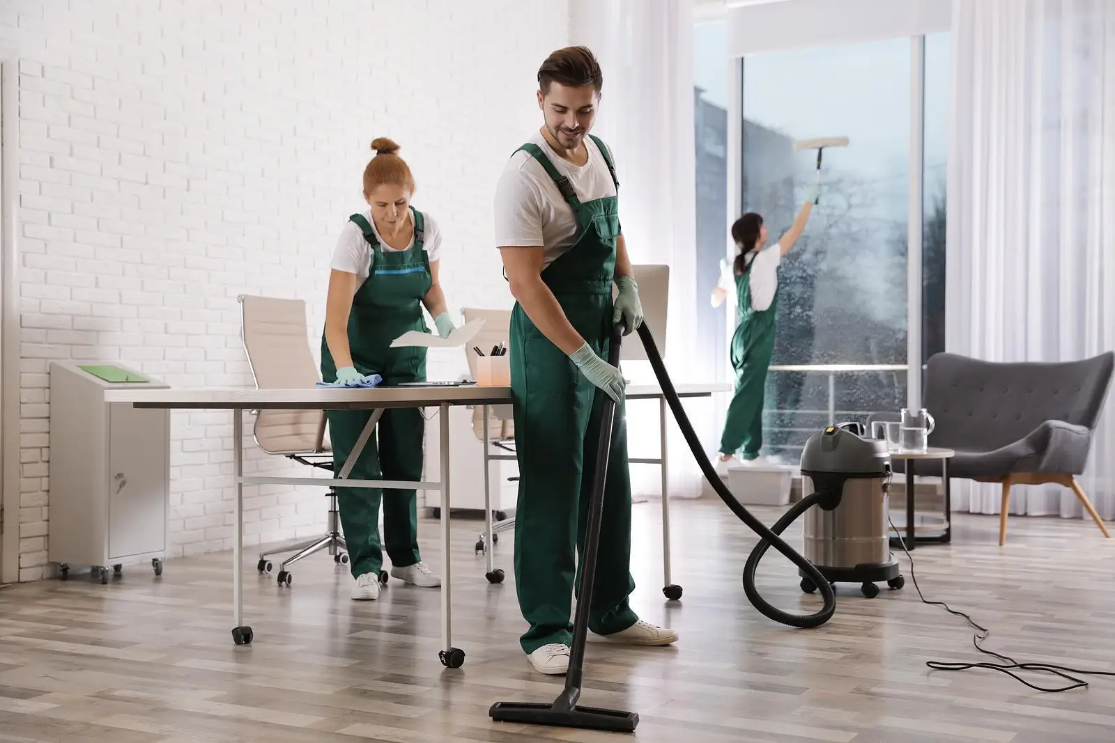 Team of Professional Janitors cleaning a office