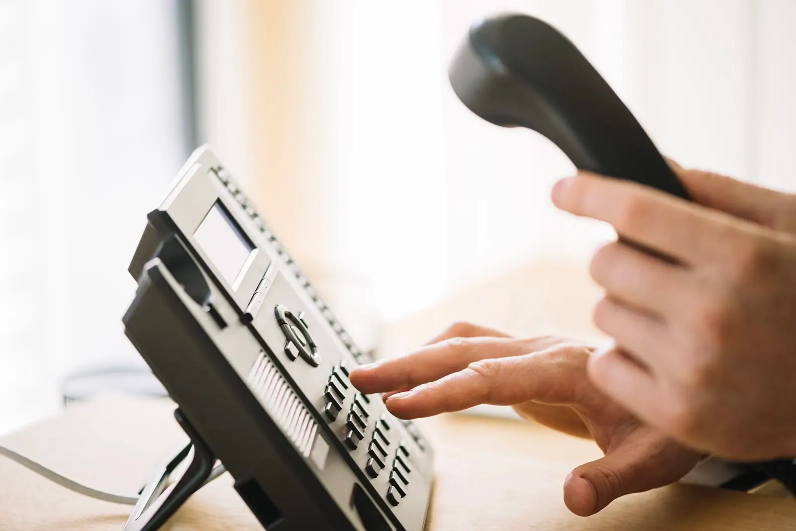 close up. of a man dialing number on a office phone