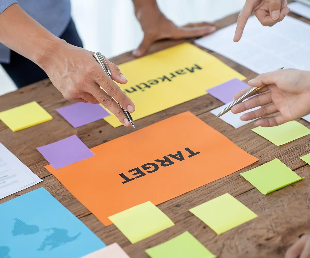 Close up of. desk with bright laid out pieces of paper and postits