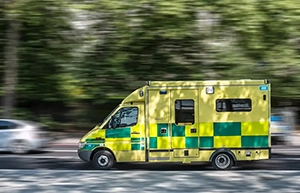 Speeding UK NHS ambulance with blurred background