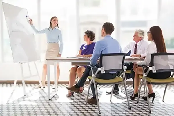 A women leading a presentation in a board room in a corporate meeting room