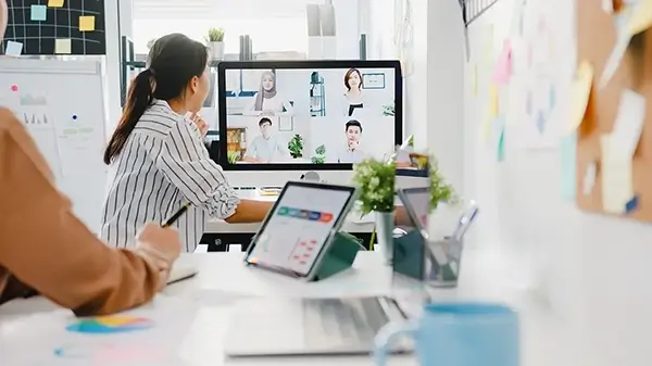 Group of Asian people using zoom for a virtual meeting in a office