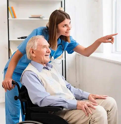 Female carer is tending to a elderly man and point out to a window