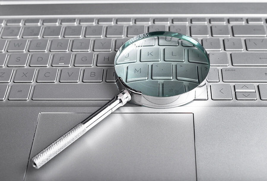 Magnifying glass over laptop computer