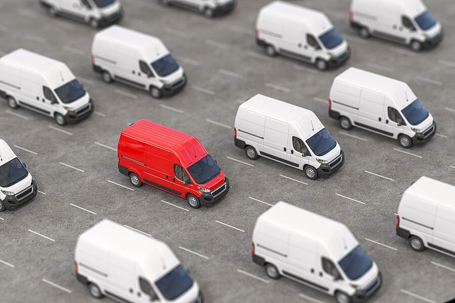 Red van in a row of white vans