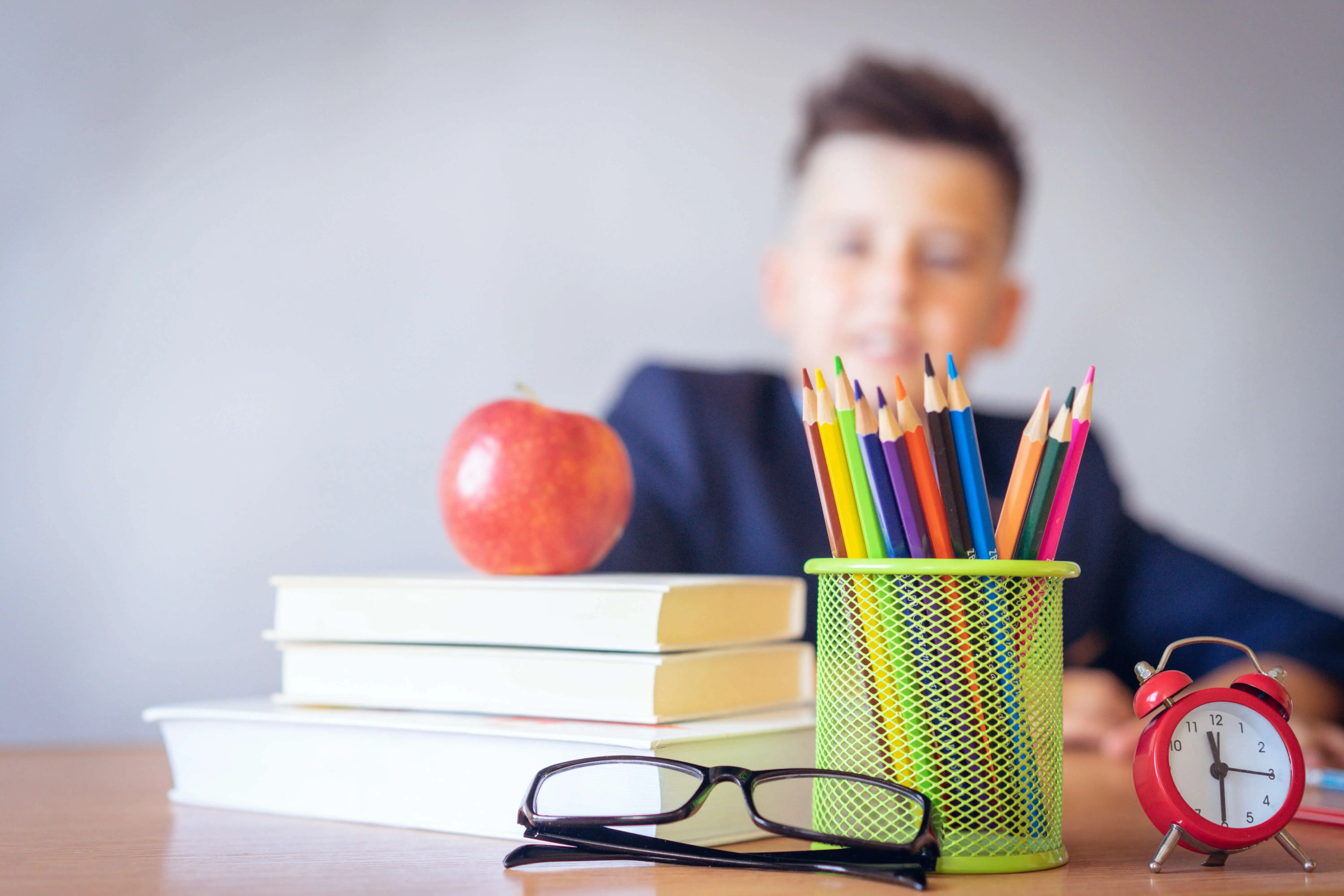 School pupil sat behind a desk
