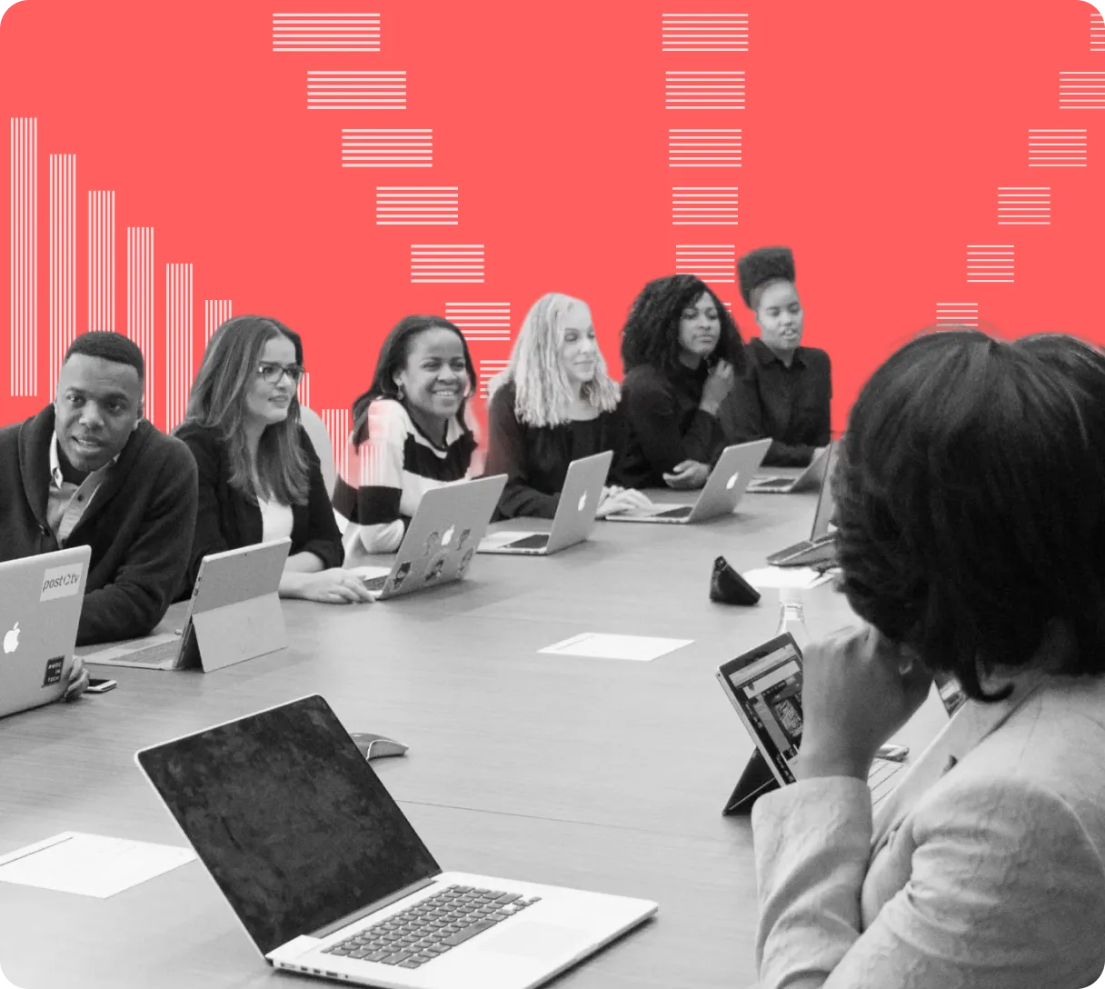 Group of diverse professionals sitting at a conference table with laptops, engaged in a meeting against a coral background with white abstract lines.