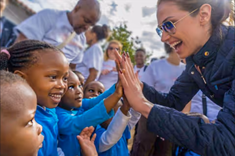 Sarah helping children
