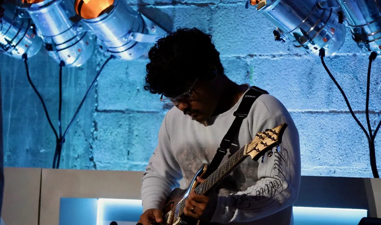 VOUS Worship guitarist playing under stage lights