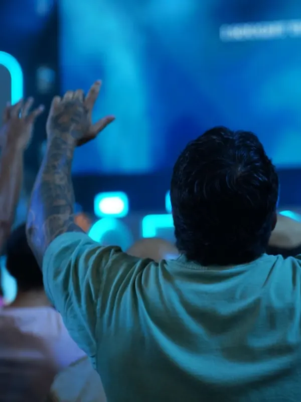 A man raises his hands in worship