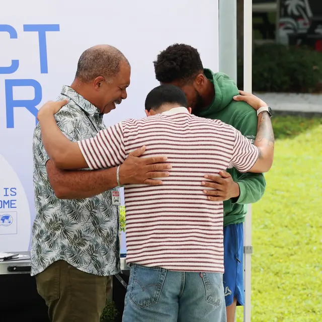 Two men hug outside after a VOUS service