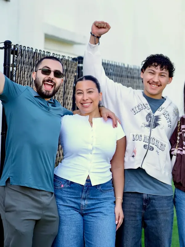 Friends cheering together outside VOUS