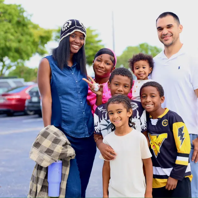 A family gathered together in the VOUS parking lot