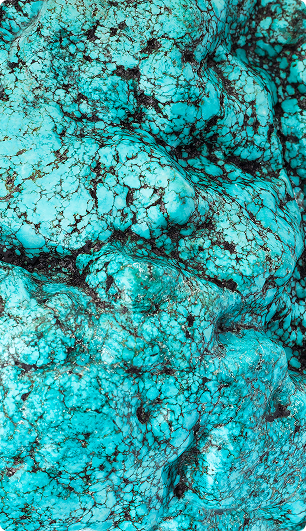 Close-up texture of turquoise stone with blue and black veining patterns.