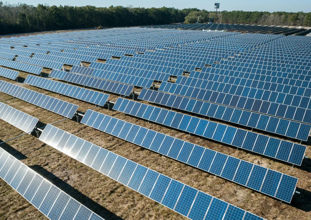 Solar farm with rows of solar panels.