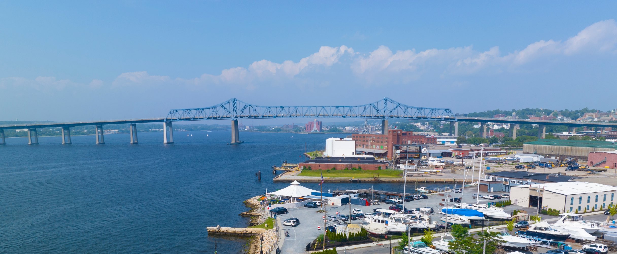 Aerial view of a coastal city with a bridge over the water.