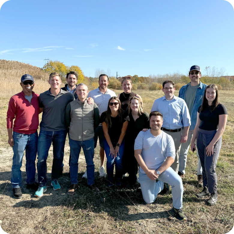 Group of people posing outdoors.