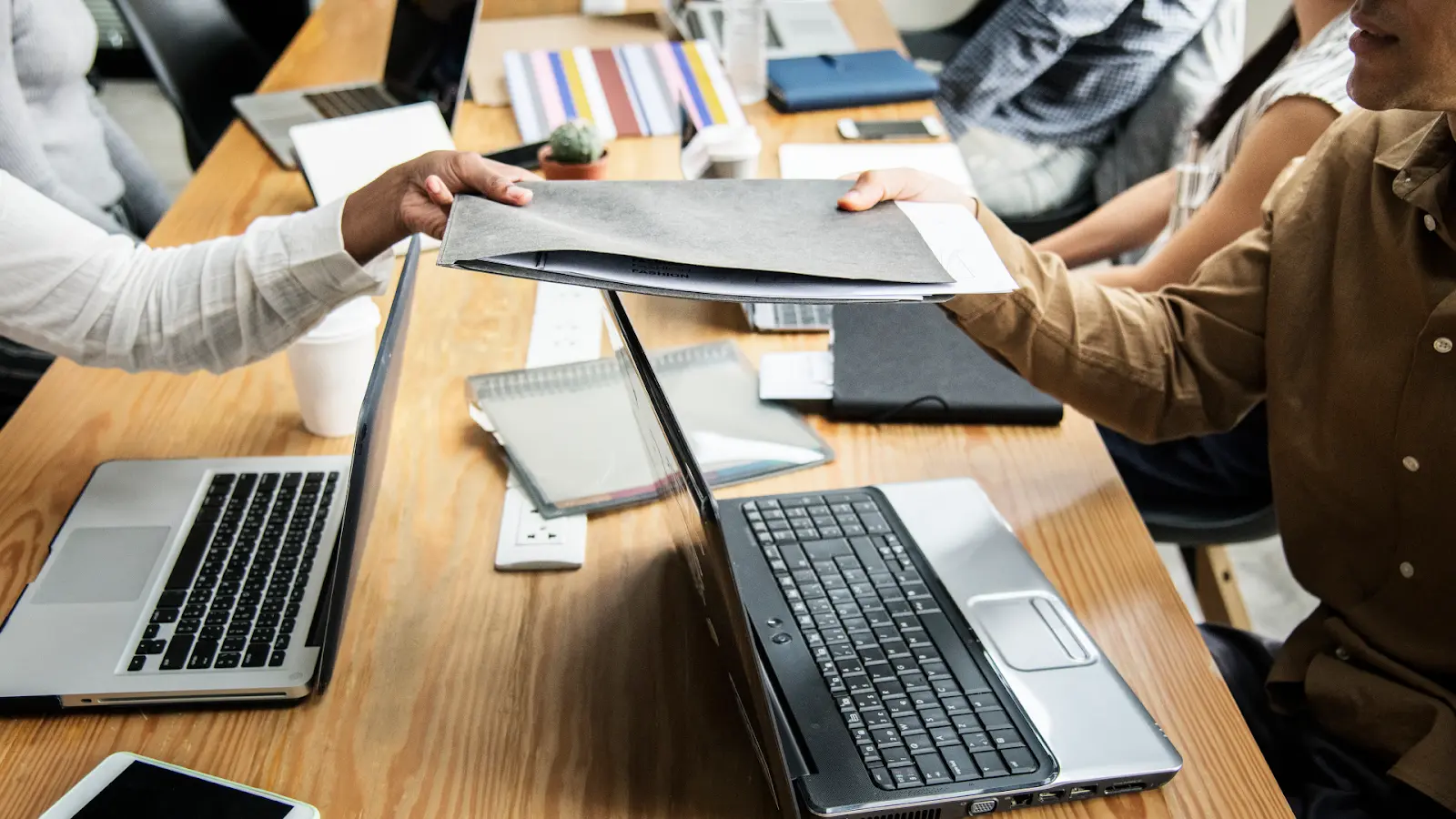 Team sharing retailer reports and claims backup while aligning cost takeout actions and owners.