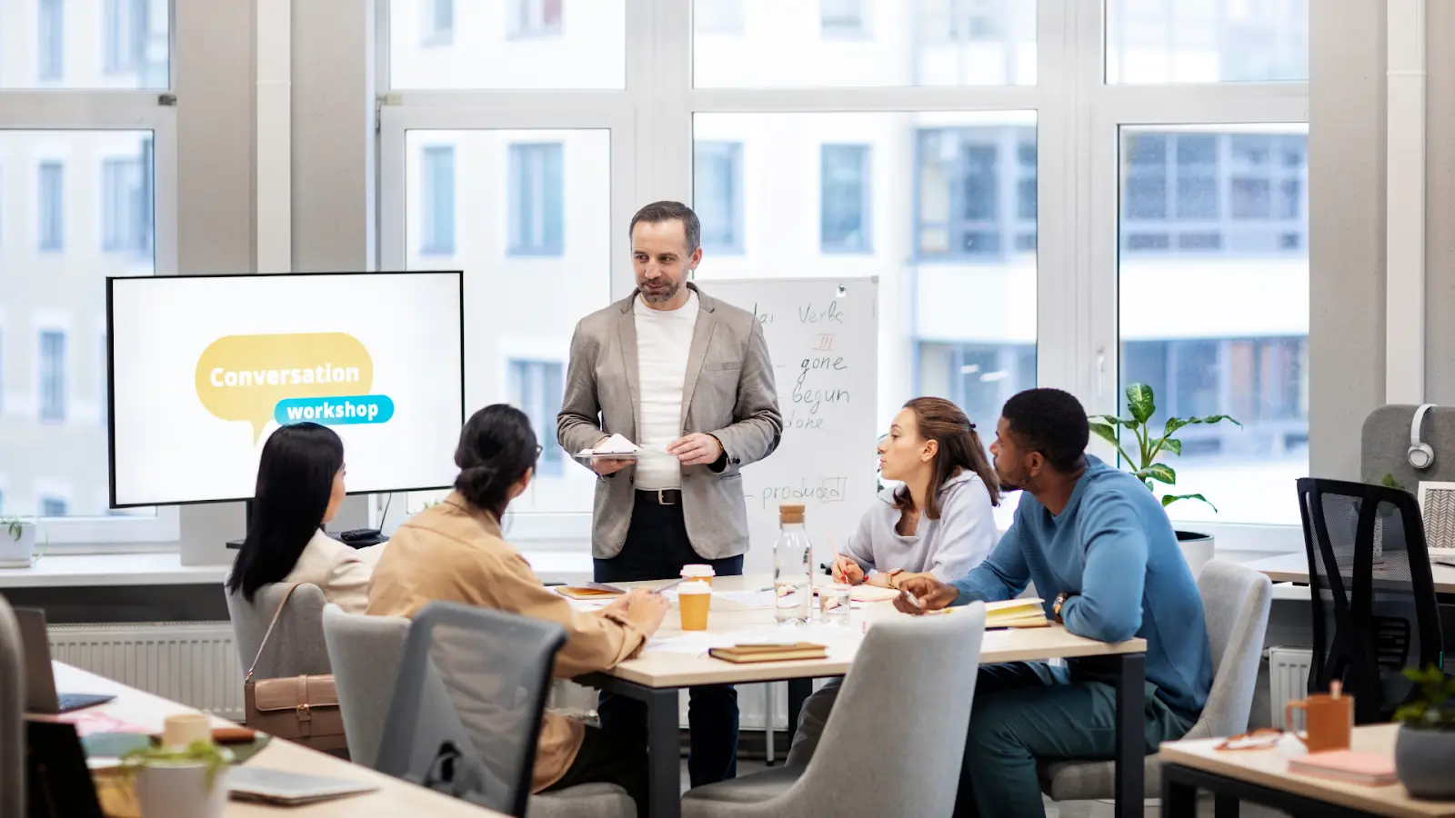 A presenter leading a workshop for a seated team as increasing Retail Pressures require faster project execution.